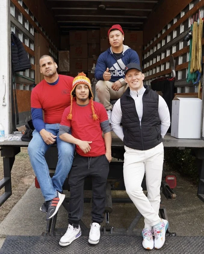 Atlanta Pack and Load team members posing in a moving truck, showcasing professionalism and teamwork in relocation services.