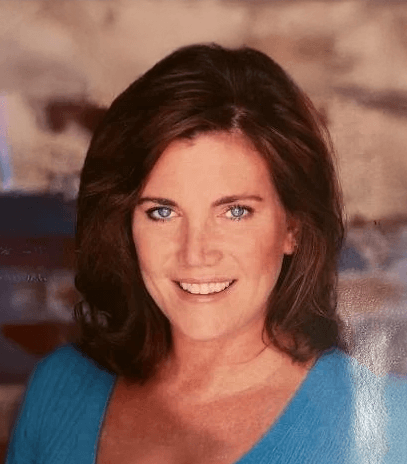 Maureen Lonati, Director of Sales and Marketing at Atlanta Pack and Load, smiling and wearing a blue top, with a blurred background reflecting the company's commitment to customer-focused moving services.