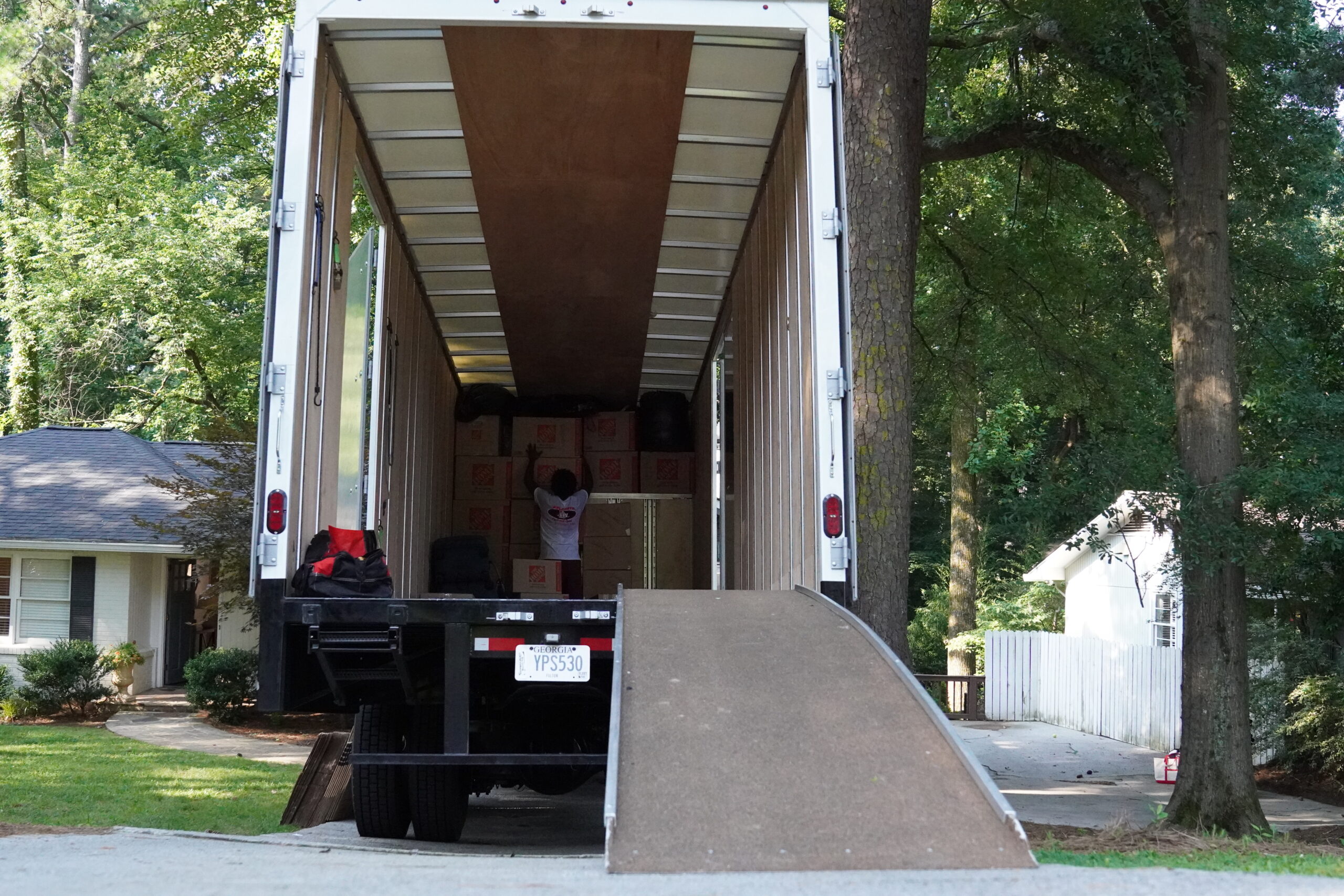 Moving truck with ramp and stacked boxes, showcasing storage solutions for a smooth move in Austell, GA.