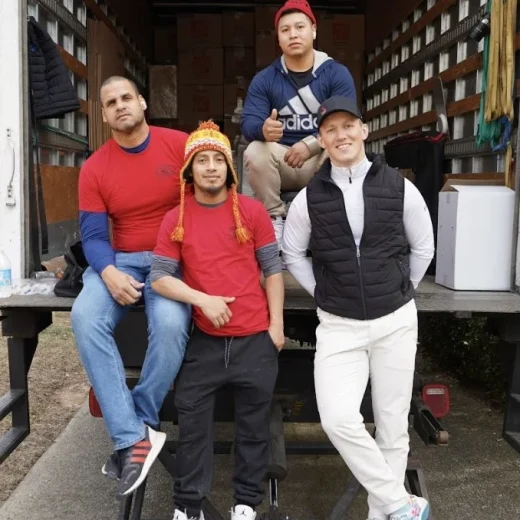 Atlanta Pack and Load moving team posing in front of a truck, showcasing professionalism and teamwork in relocation services.